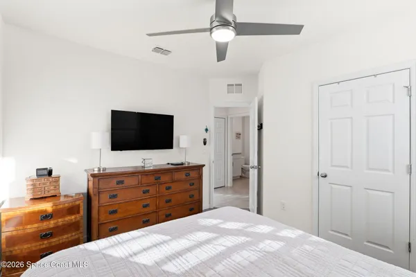 a bedroom with a bed and a flat screen tv