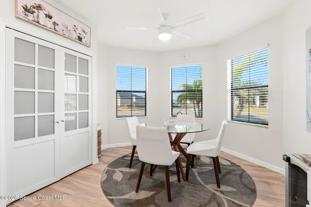 a view of a dining room with furniture window and wooden floor