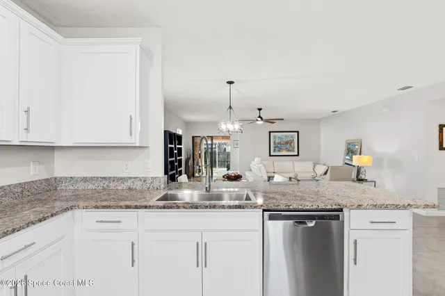 a kitchen with granite countertop stainless steel appliances sink and cabinets