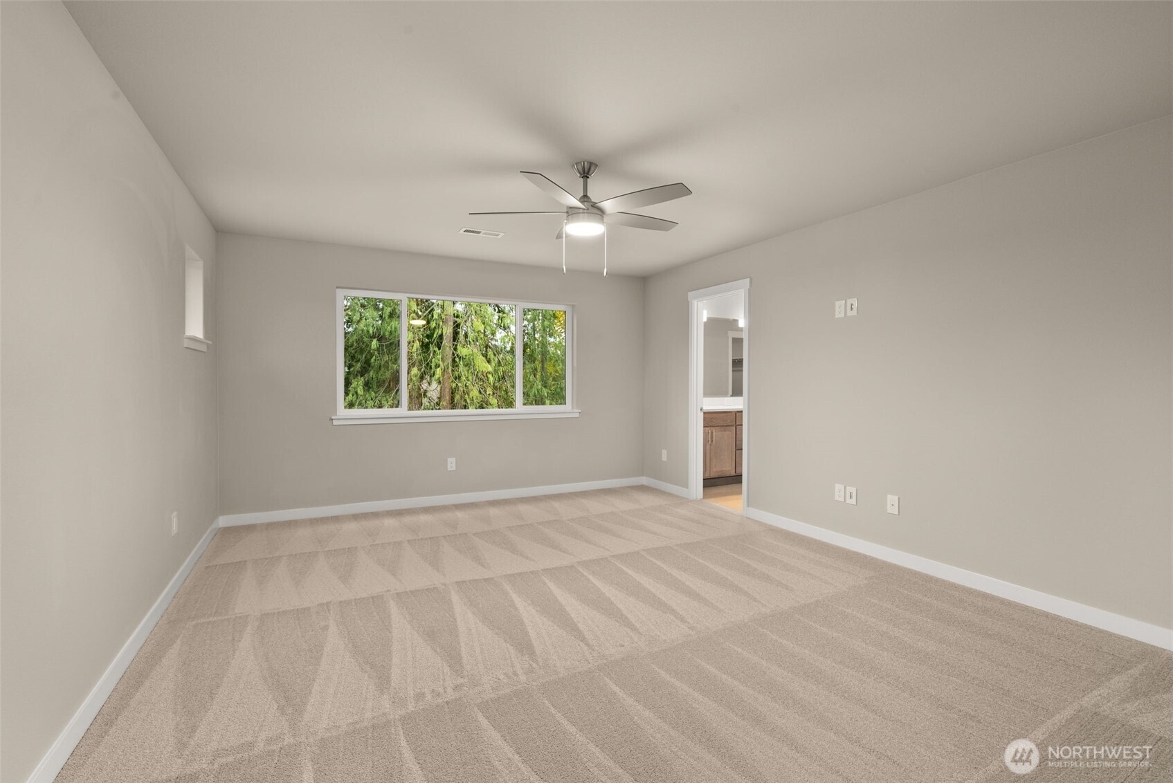 5654 Mimi Street Southwest Tumwater, WA 98512 - Photo 17 of 38 an empty room with windows and ceiling fan