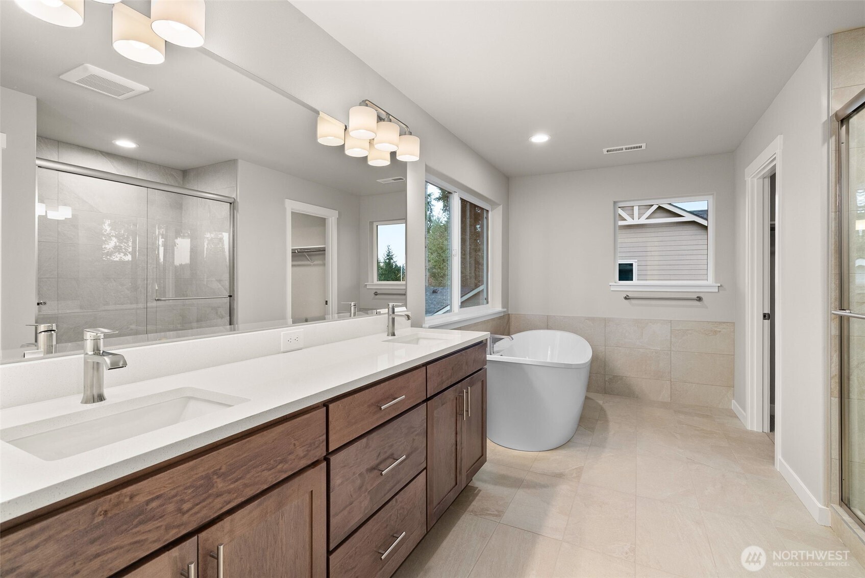 5654 Mimi Street Southwest Tumwater, WA 98512 - Photo 18 of 38 a spacious bathroom with a double vanity sink mirror and toilet