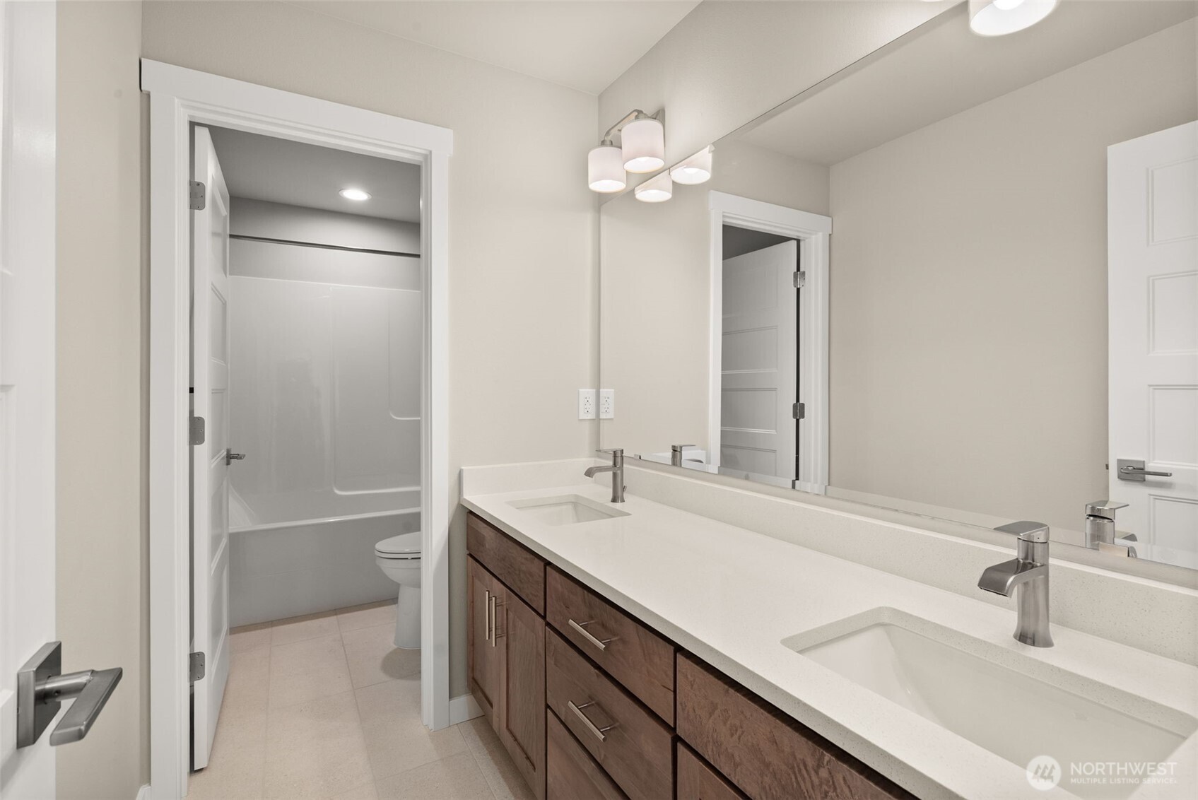 5654 Mimi Street Southwest Tumwater, WA 98512 - Photo 25 of 38 a bathroom with a sink double vanity and a mirror
