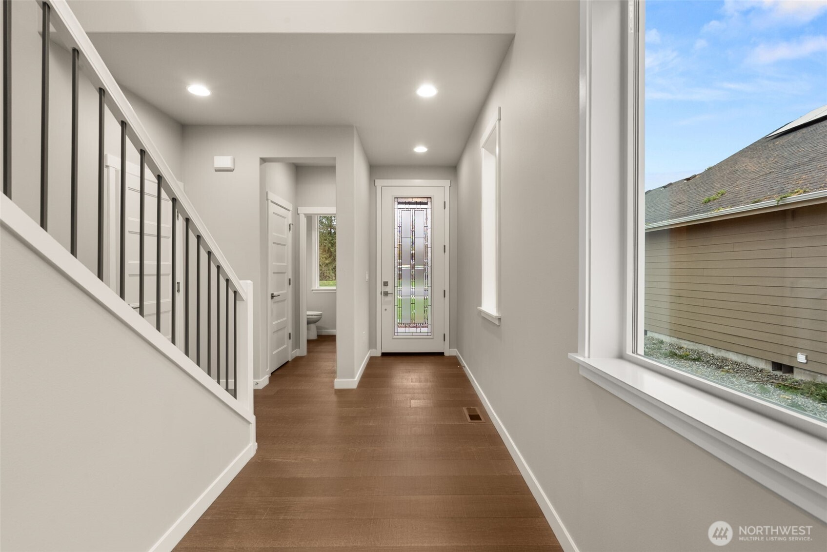 5654 Mimi Street Southwest Tumwater, WA 98512 - Photo 3 of 38 a view of a hallway with wooden floor and staircase