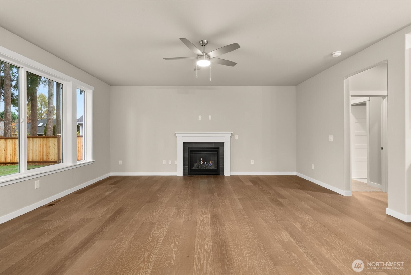 5654 Mimi Street Southwest Tumwater, WA 98512 - Photo 4 of 38 a view of an empty room with a window and fireplace