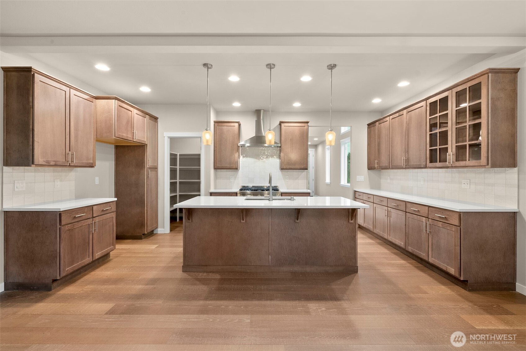 5654 Mimi Street Southwest Tumwater, WA 98512 - Photo 6 of 38 a large kitchen with kitchen island granite countertop a large counter top stainless steel appliances and cabinets