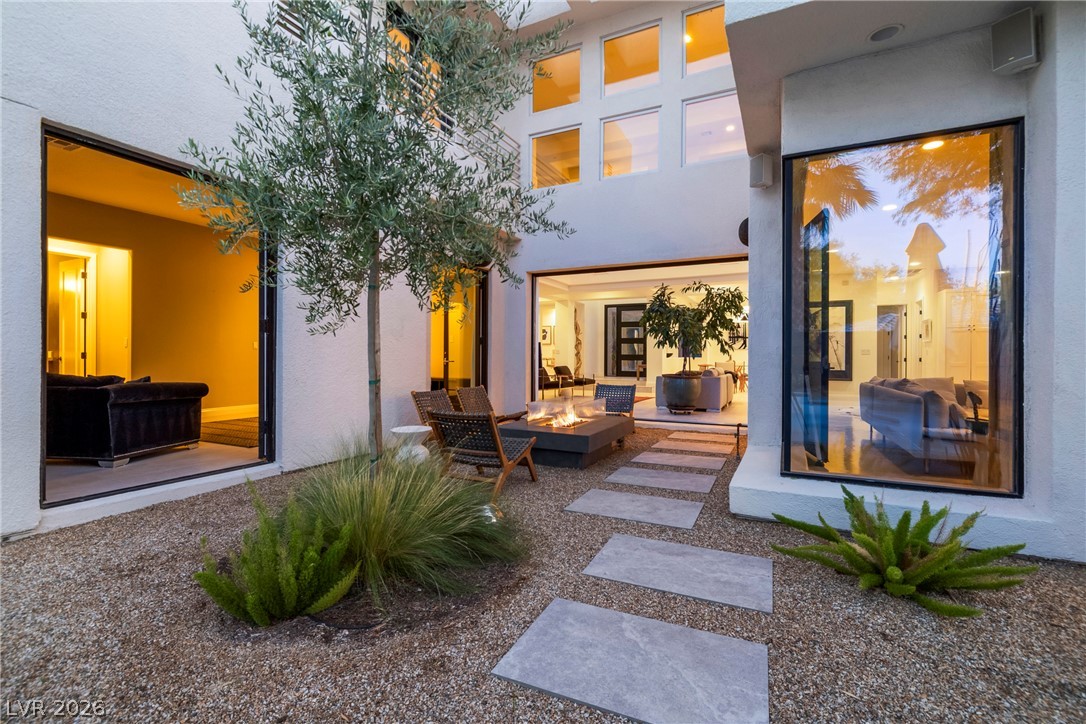 2000 Grouse Street Las Vegas, NV 89134 - Photo 57 of 89 An inviting private courtyard with a fire pit and serene landscaping, seamlessly blending indoor and outdoor living.