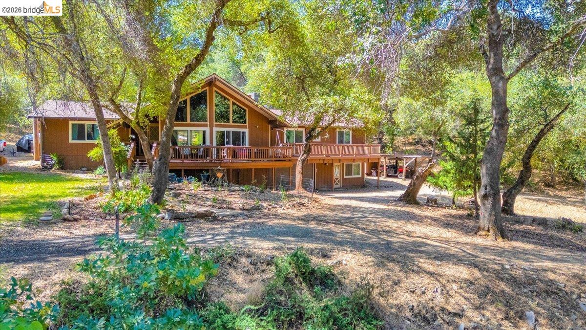 8733 Fraguero Road Sonora, CA 95370 - Photo 6 of 73 Wood-sided residence featuring a prominent A-frame window design and a full-length deck