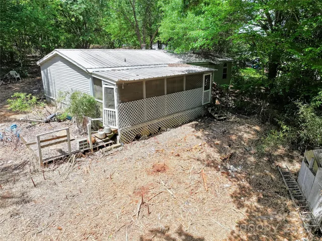 a view of a house with a yard and sitting area