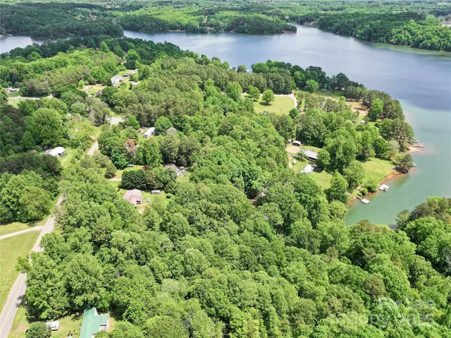 an aerial view of a house with a yard and outdoor seating