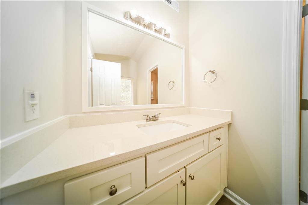 11171 Knotty Pine Place Hampton, GA 30228 - Photo 13 of 26 a bathroom with a sink and a mirror