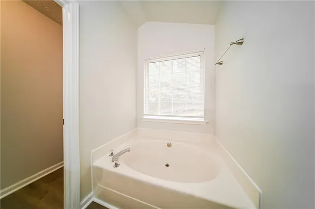 a white bath tub sitting next to a window