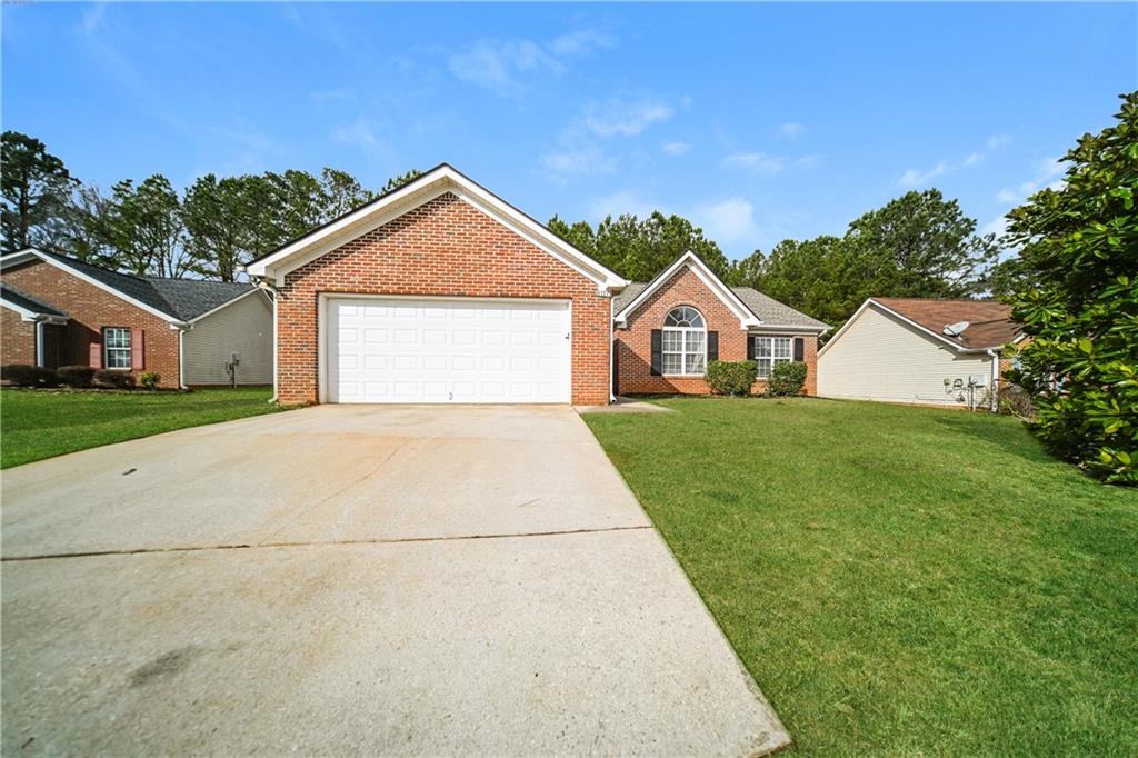 11171 Knotty Pine Place Hampton, GA 30228 - Photo 25 of 26 a view of house with yard and garage