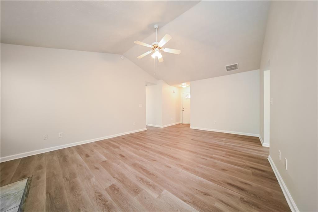 11171 Knotty Pine Place Hampton, GA 30228 - Photo 4 of 26 a view of empty room with wooden floor and fan