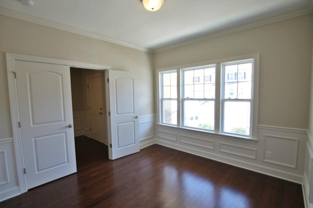 2191 Bluebell Way, Unit 11 Tega Cay, SC 29708 - Photo 2 of 14 an empty room with wooden floor and windows