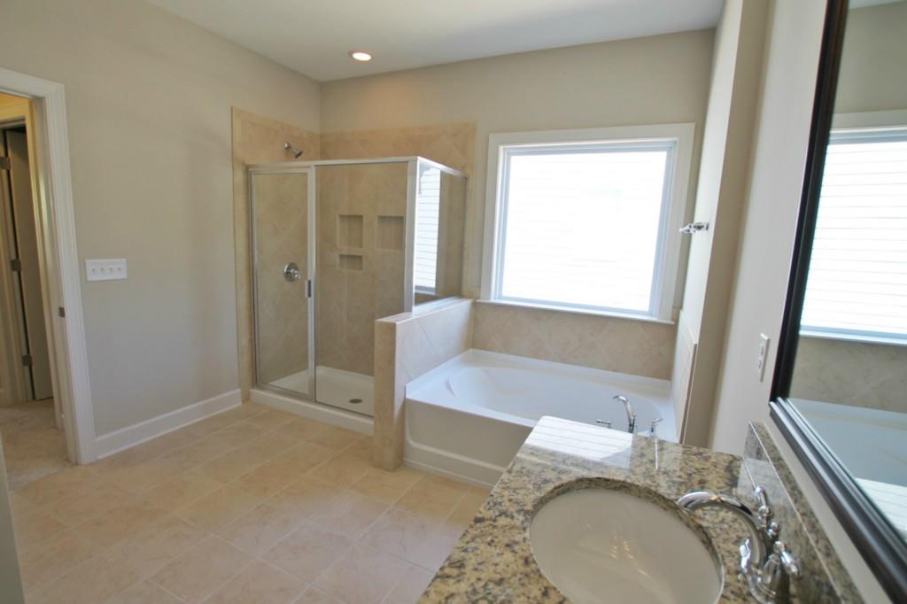 2191 Bluebell Way, Unit 11 Tega Cay, SC 29708 - Photo 11 of 14 a bathroom with a granite countertop sink and a mirror