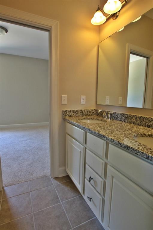 2191 Bluebell Way, Unit 11 Tega Cay, SC 29708 - Photo 13 of 14 a bathroom with a granite countertop sink and a mirror