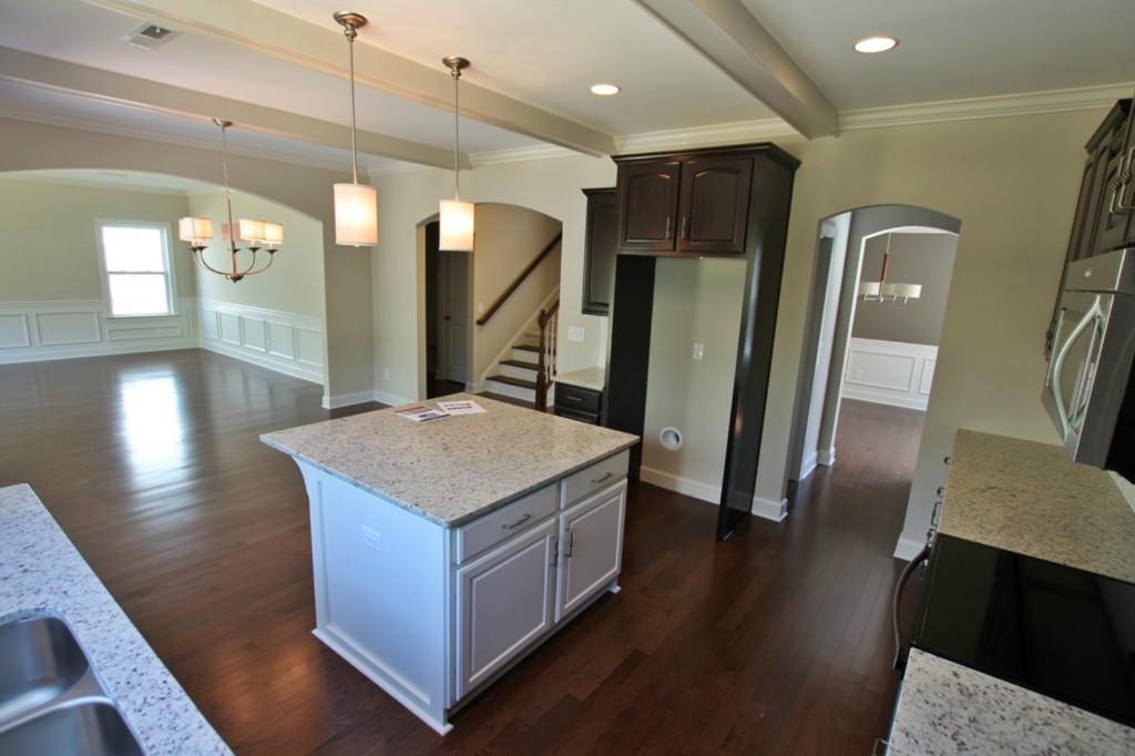 2191 Bluebell Way, Unit 11 Tega Cay, SC 29708 - Photo 5 of 14 a kitchen with stainless steel appliances granite countertop a refrigerator a sink and wooden floor