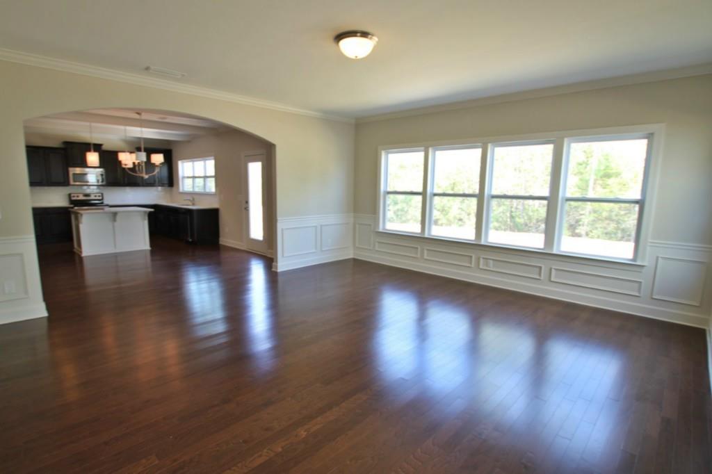 2191 Bluebell Way, Unit 11 Tega Cay, SC 29708 - Photo 8 of 14 a view of empty room with wooden floor and fireplace