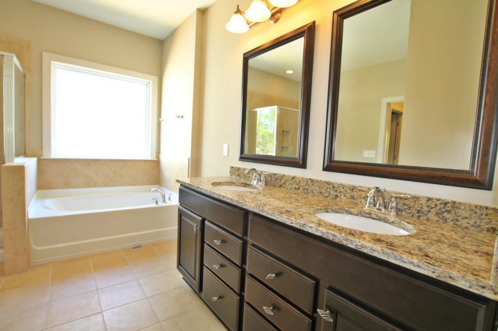 2191 Bluebell Way, Unit 11 Tega Cay, SC 29708 - Photo 10 of 14 a bathroom with a granite countertop sink and a bathtub