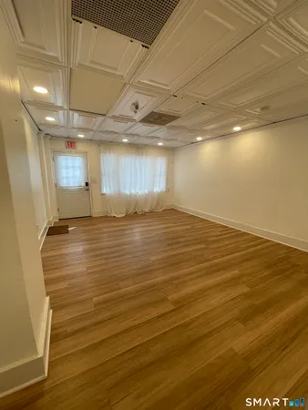 a view of a room with wooden floor