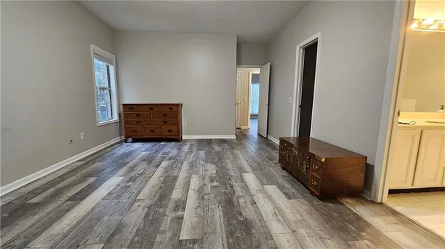 a view of room with window and wooden floor