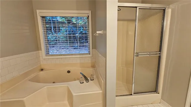 a bathroom with a tub and shower