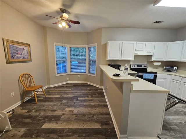 a kitchen with cabinets a sink and appliances