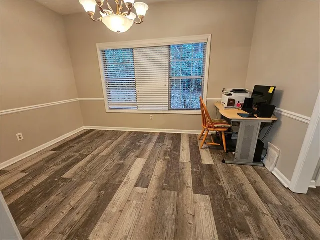 a view of a workspace with wooden floor