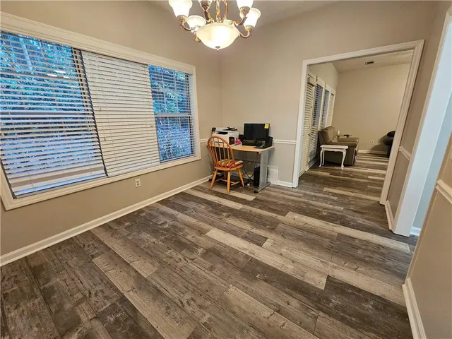 a view of a bedroom with a window and furniture