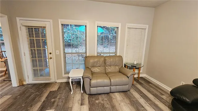 a living room with furniture and two window