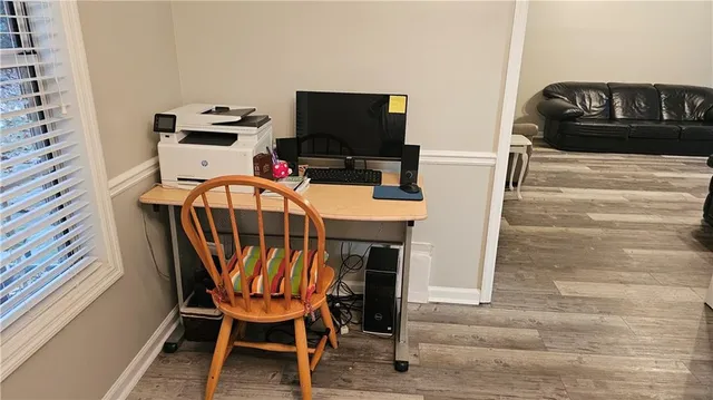 a dining room with furniture and wooden floor