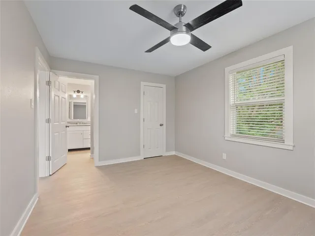 a bathroom with a granite countertop sink a toilet and bathtub