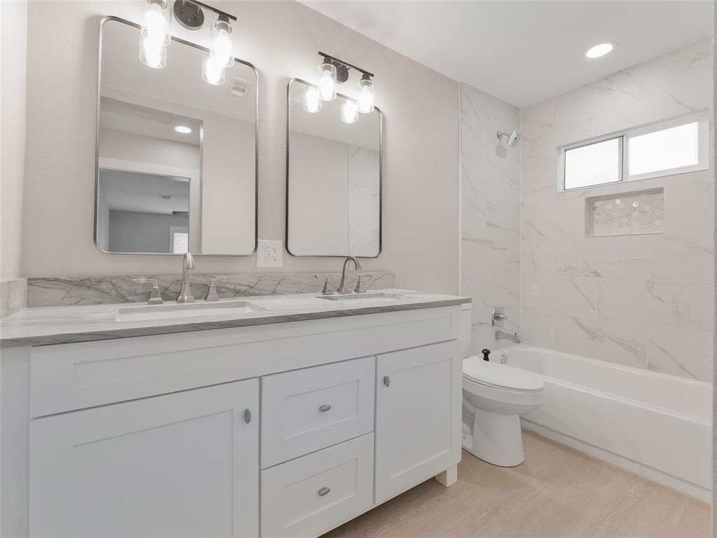 421 South Interurban Street Anna, TX 75409 - Photo 22 of 27 a bathroom with a granite countertop sink a toilet and bathtub