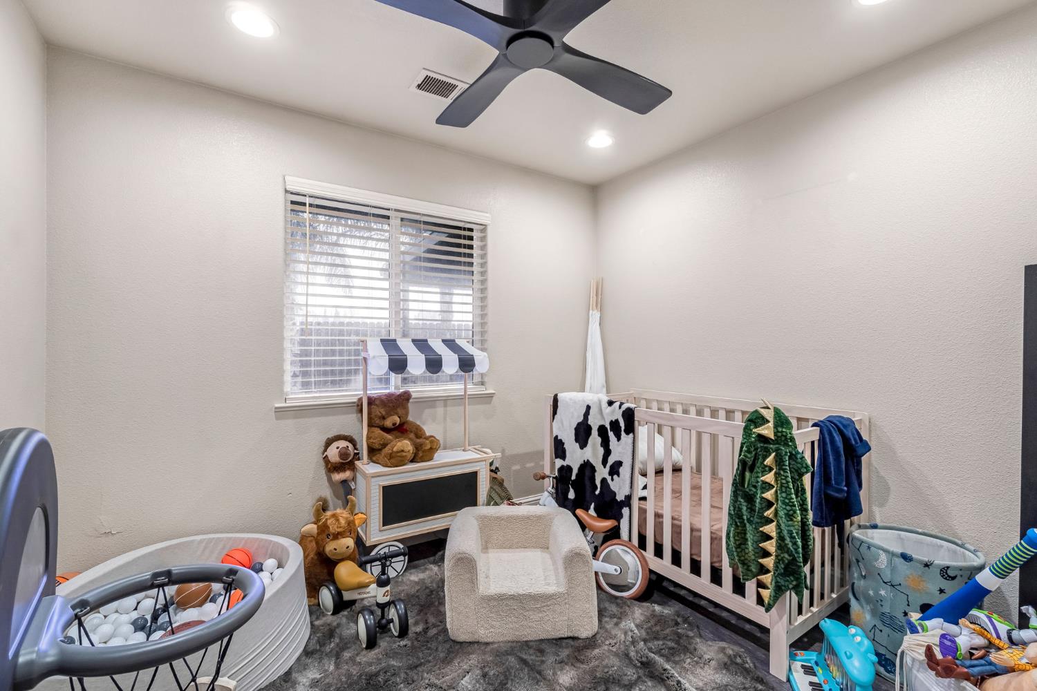 25802 El Monte Way Madera, CA 93638 - Photo 19 of 39 bedroom featuring a textured wall, a crib, a ceiling fan, and recessed lighting