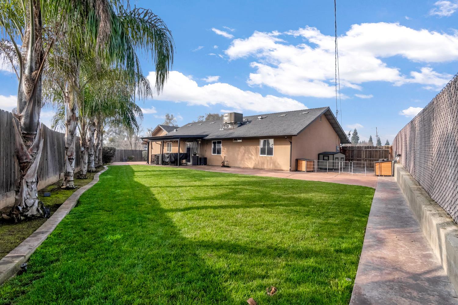 25802 El Monte Way Madera, CA 93638 - Photo 27 of 39 rear view of property featuring stucco siding, a fenced backyard, and a patio