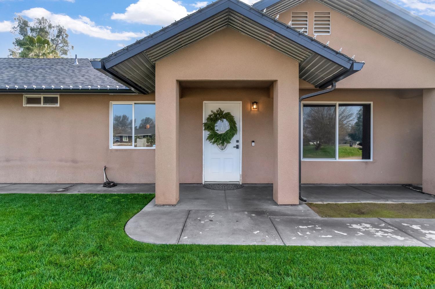 25802 El Monte Way Madera, CA 93638 - Photo 4 of 39 doorway to property featuring stucco siding and a yard