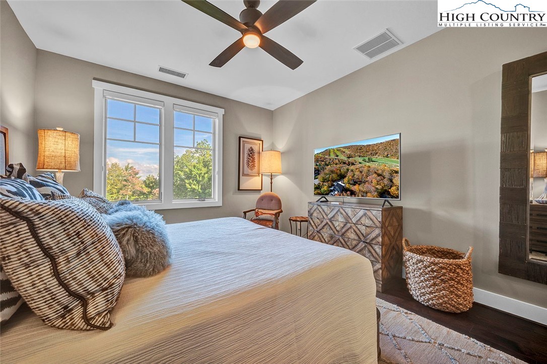188 Ramblestone Terrace, Unit 101 Boone, NC 28607 - Photo 22 of 48 a bed sitting in a bedroom next to a window