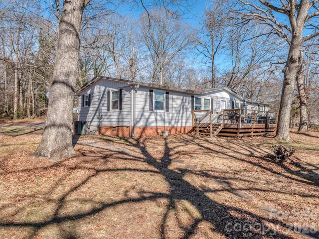 a front view of a house with cars parked on road