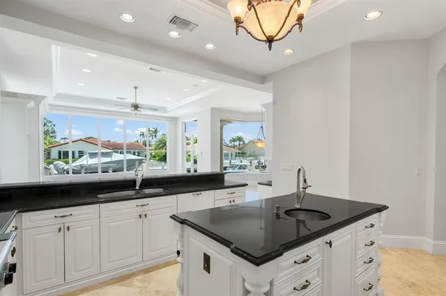 a living room with a large window and a chandelier