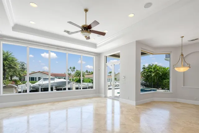 a view of an empty room with a window and cabinet