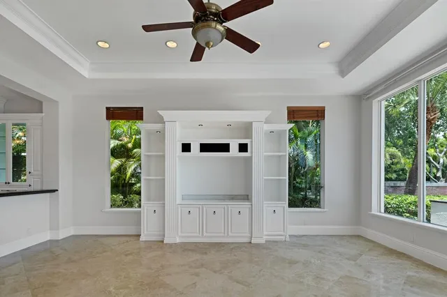 a view of a room with a large window and chandelier