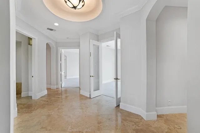 an empty room with windows and cabinet