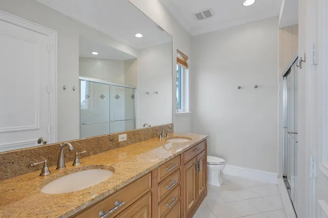 an aerial view of a house with swimming pool and lake view