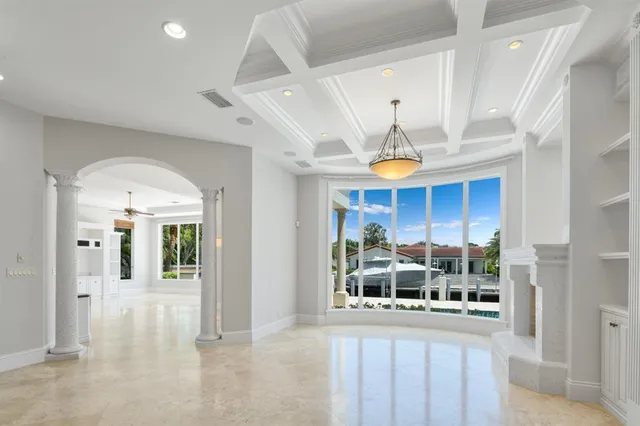 a view of a hallway with entryway and chandelier