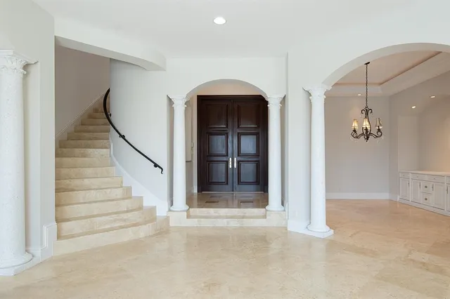 a view of a livingroom with a staircase and a fireplace