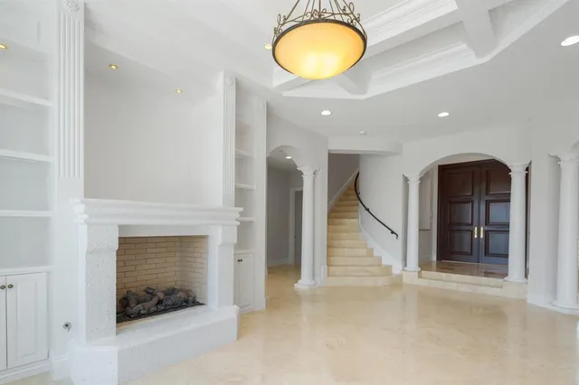 a view of a big room with chandelier and windows