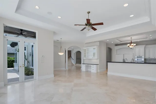 a kitchen with granite countertop a sink cabinets stainless steel appliances and a large window