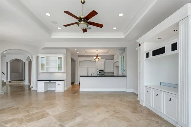 a kitchen with stainless steel appliances granite countertop a sink and a white wooden cabinets