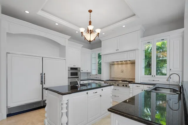 a view of a kitchen with refrigerator and window