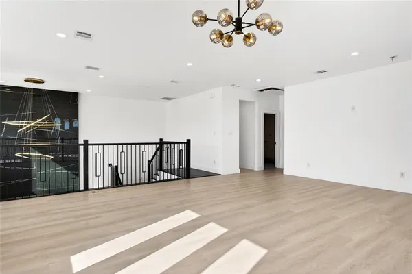 a view of a room with a window and a ceiling fan